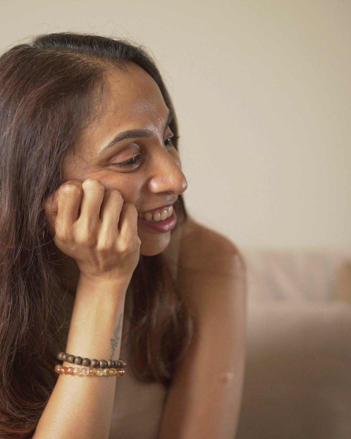 Archana Dandapani, founder of Anvi Earth, resting her chin on her hand with a warm smile