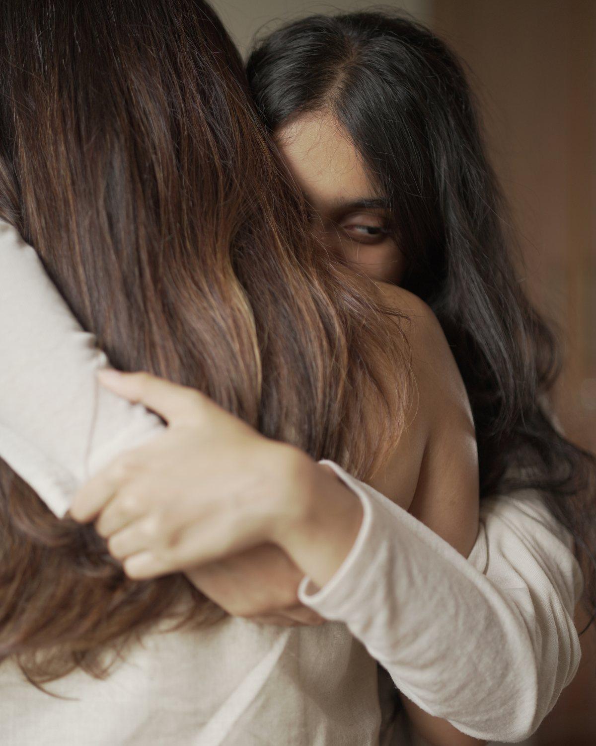 A mother and daughter in a warm embrace