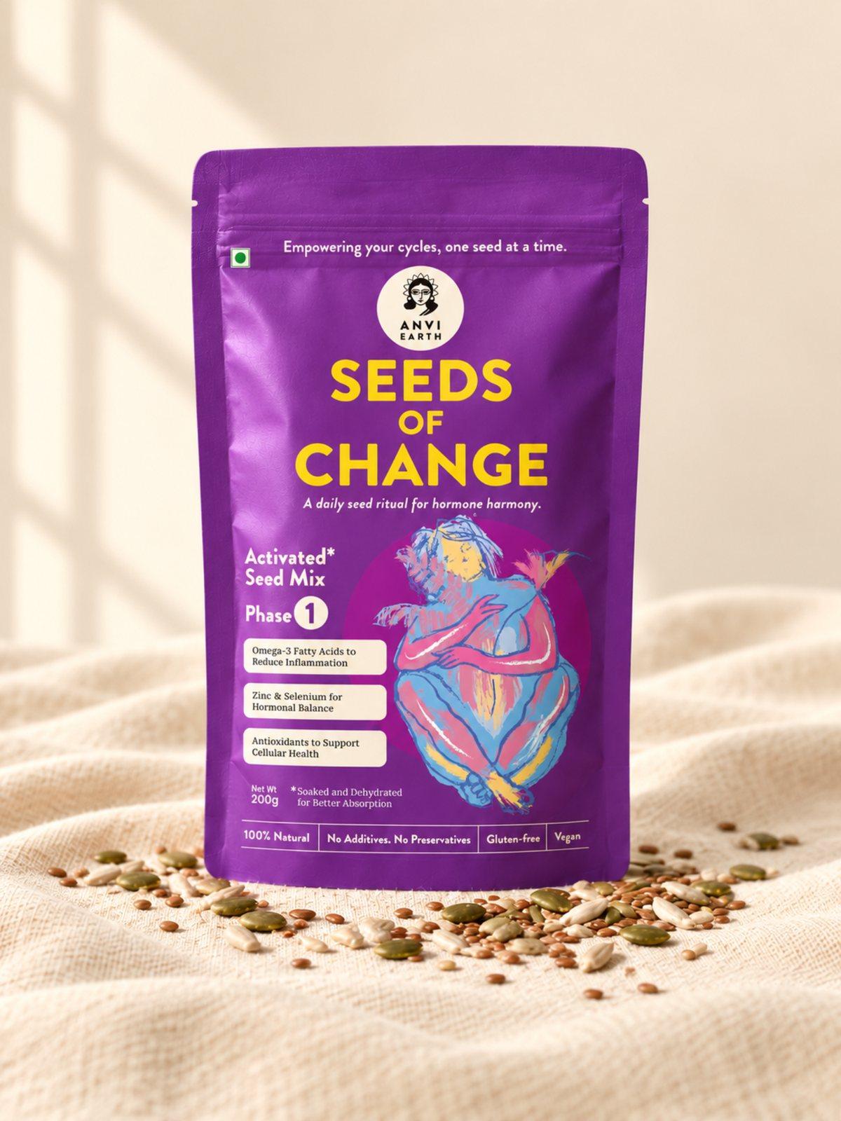 Seeds of Change Phase 1 pouch standing on cream linen with its seeds scattered at the base